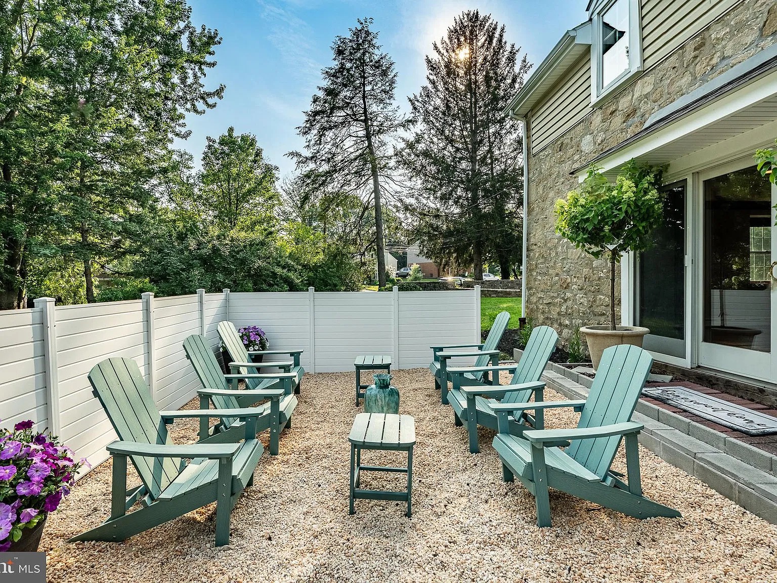 Gravel patio with Adirondack chairs