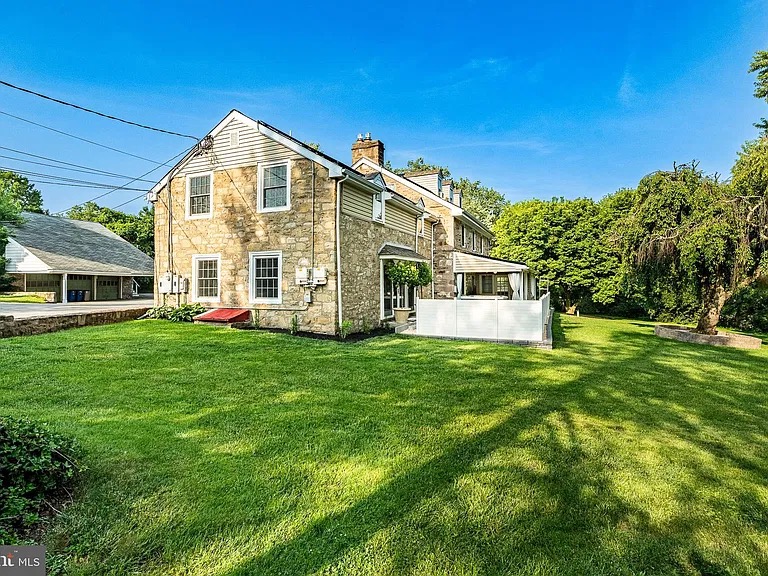 Backyard with enclosed patio and detached garage