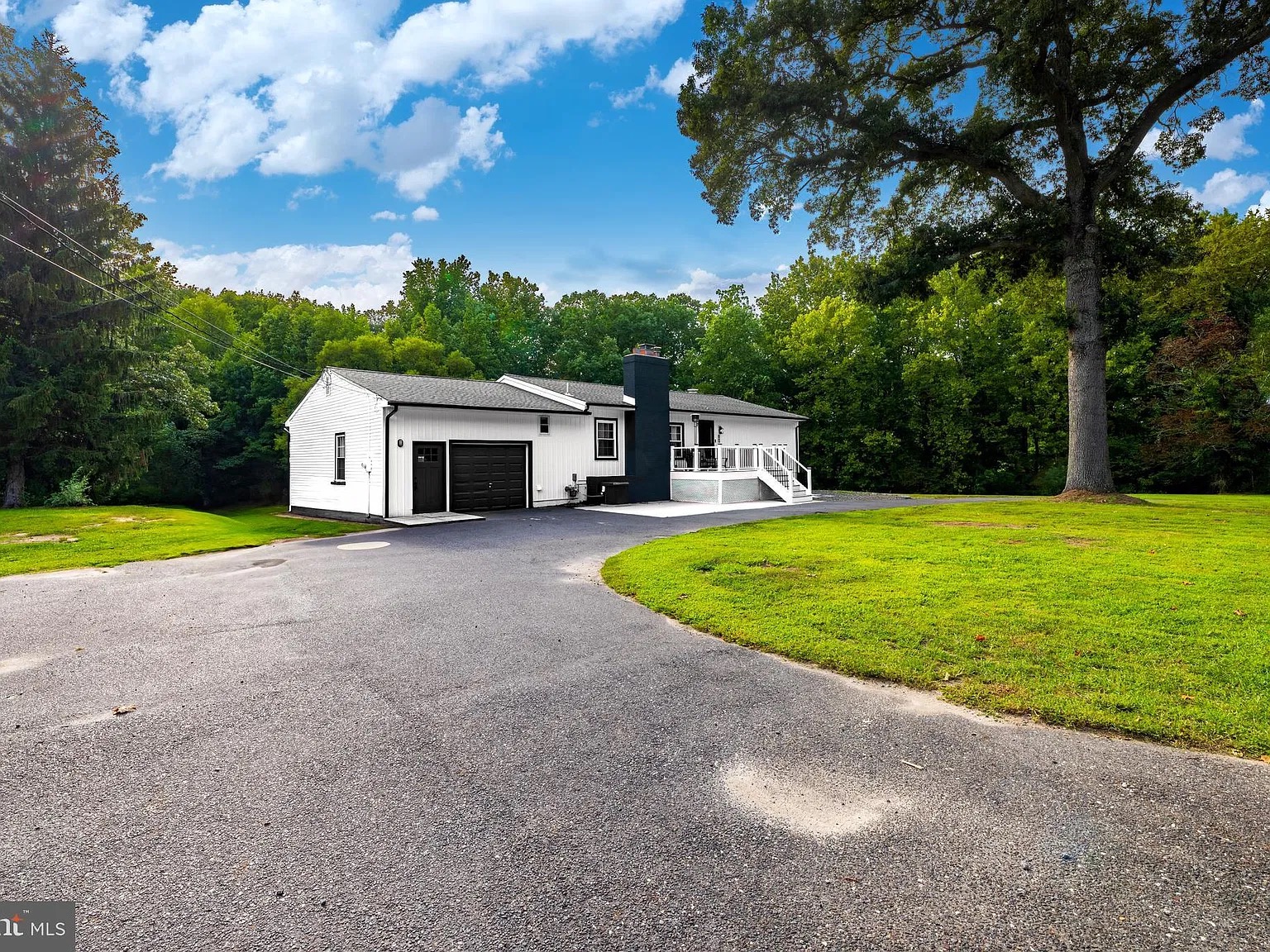 Front of the house with driveway and lawn